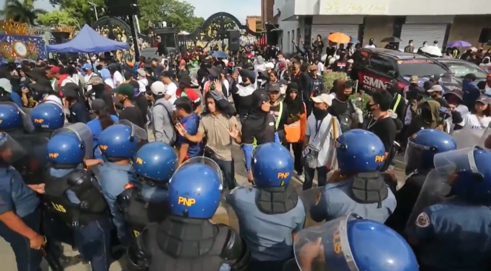 a crowd of people wearing pnp helmets stand in a line