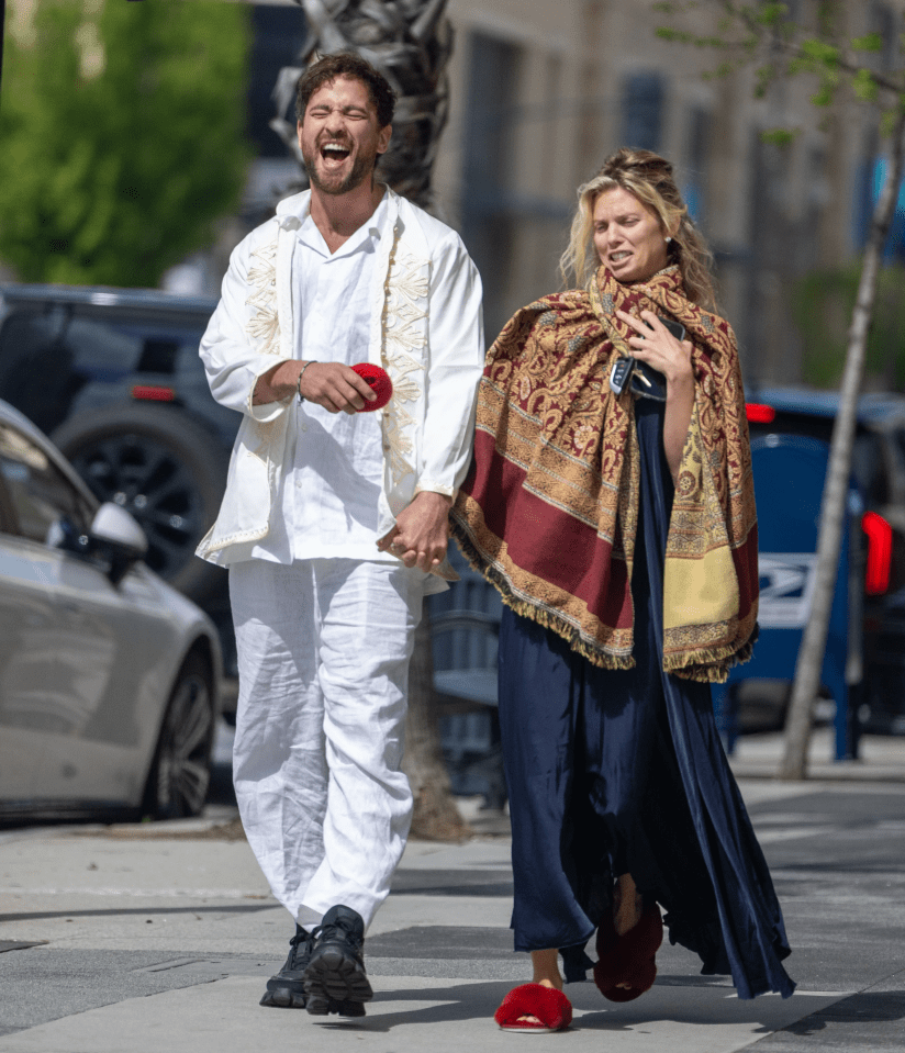 a man and a woman are walking down the street holding hands