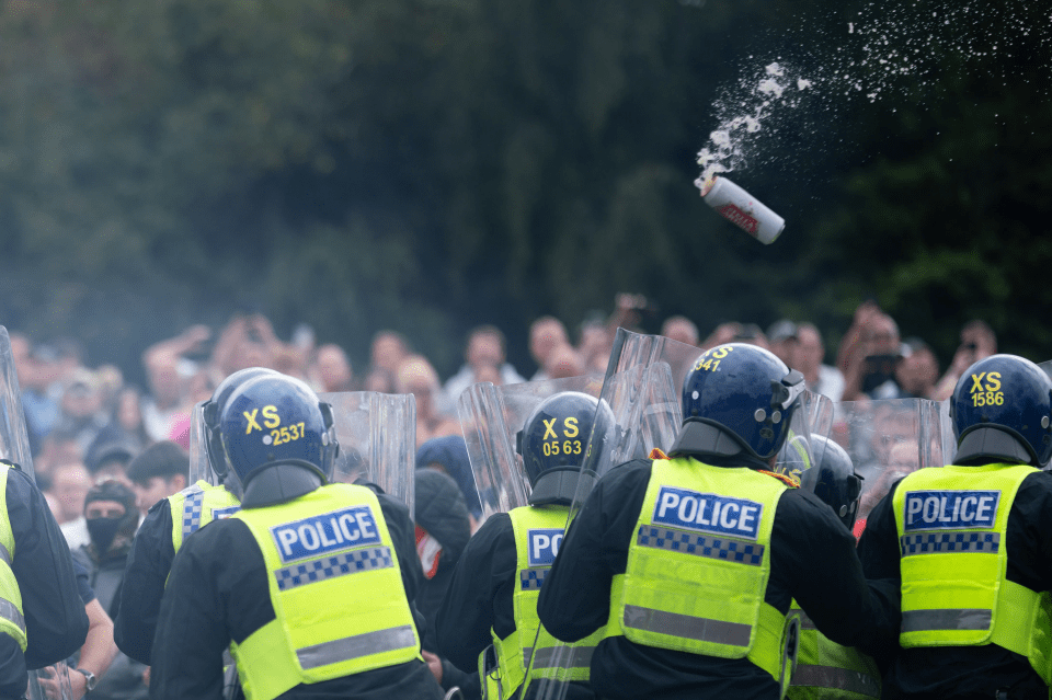 a group of police officers with xs helmets