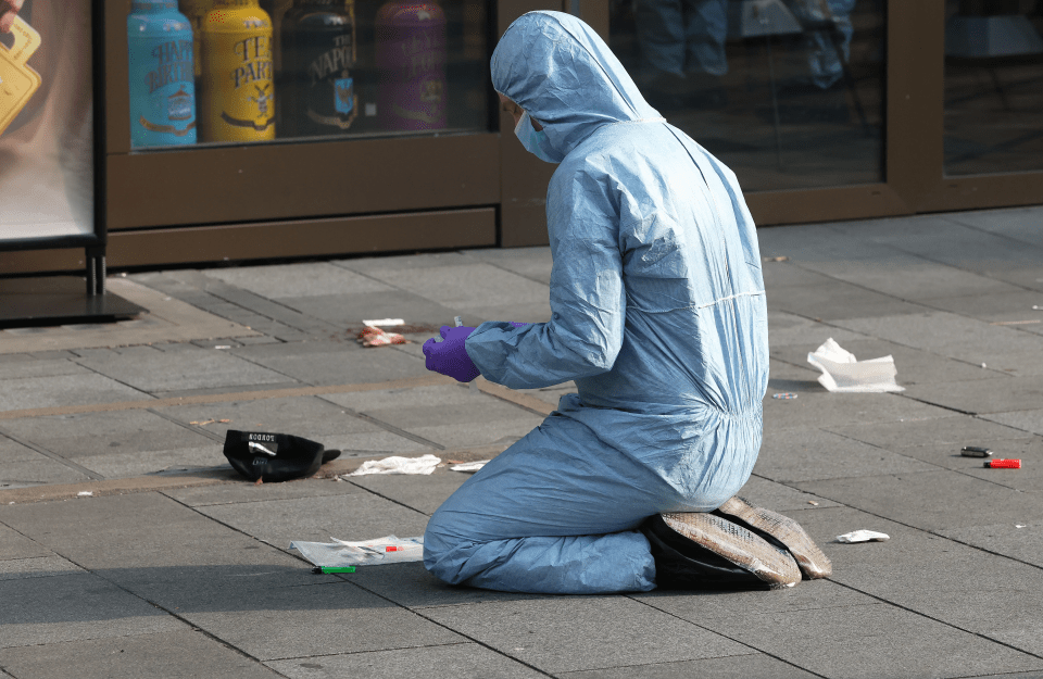 a person in a blue suit is kneeling on the ground