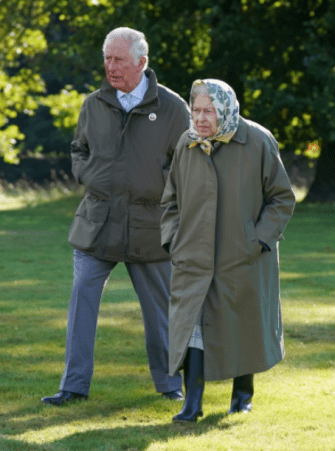 Queen Elizabeth II and Charles walk to the Balmoral Cricket Pavilion in 2021