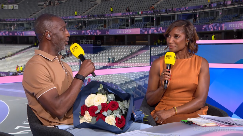 a man and a woman are sitting in front of microphones that say bbc sport