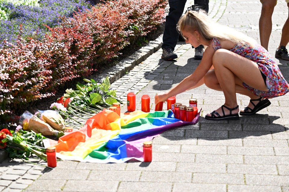 Mourners leave candles at the site of the horrific attack