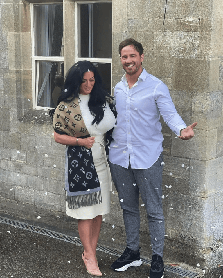 a woman in a louis vuitton scarf stands next to a man in a white shirt