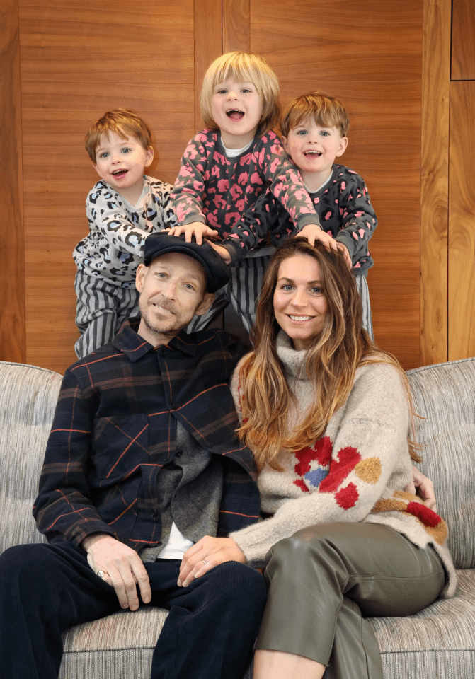 a family posing for a picture while sitting on a couch