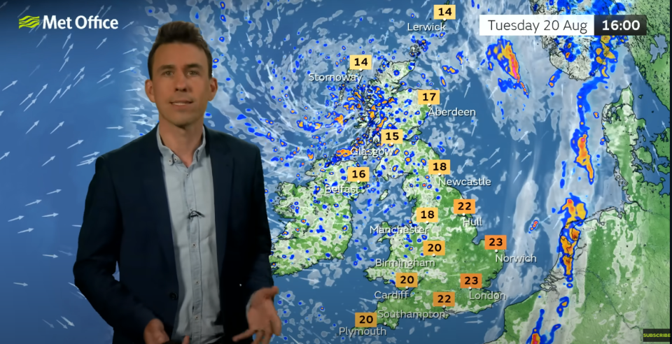 Met Office meteorologist Aidan McGivern standing in front of today's weather forecast - with 23C predicted in London