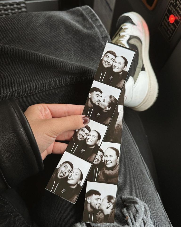 a person is holding a row of photo booth pictures of a man and woman kissing