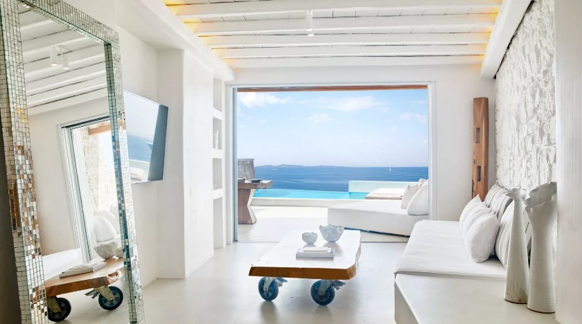 a living room with a view of the ocean