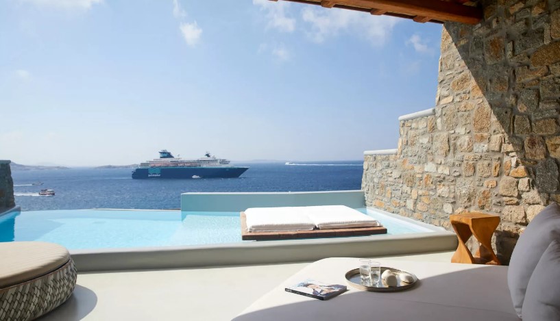 a swimming pool with a cruise ship in the background