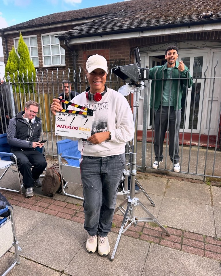 a woman holding a clapper board that says waterloo road