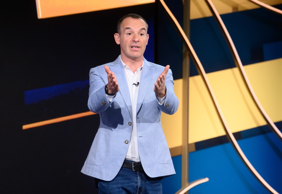 a man in a blue jacket is giving a speech