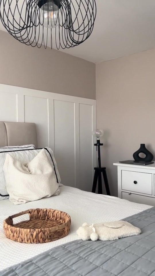 a bedroom with a wicker tray on the bed