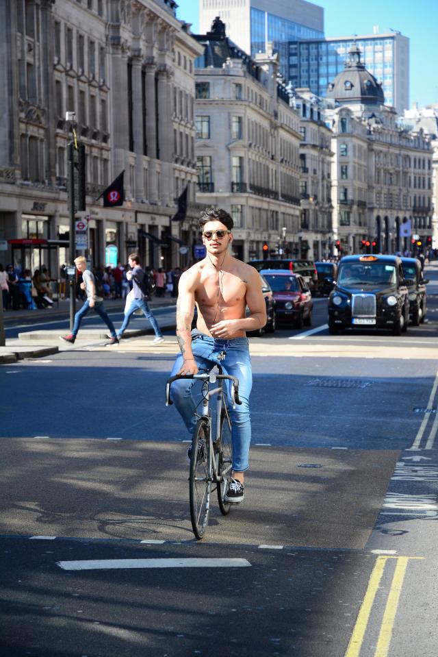 A topless man cycling on Regent Street in London