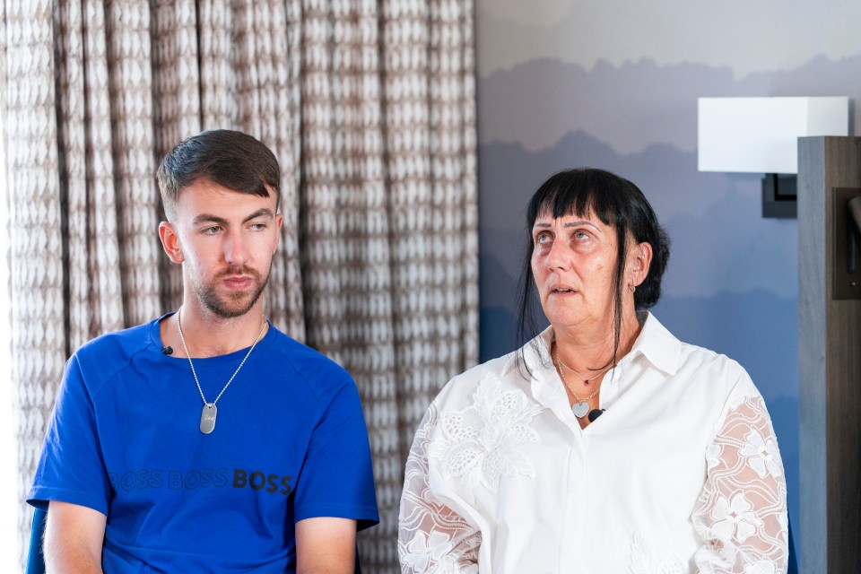 a man wearing a blue boss boss shirt sits next to a woman