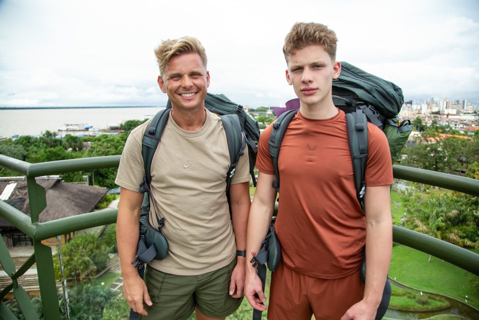 a man wearing a nike shirt stands next to another man