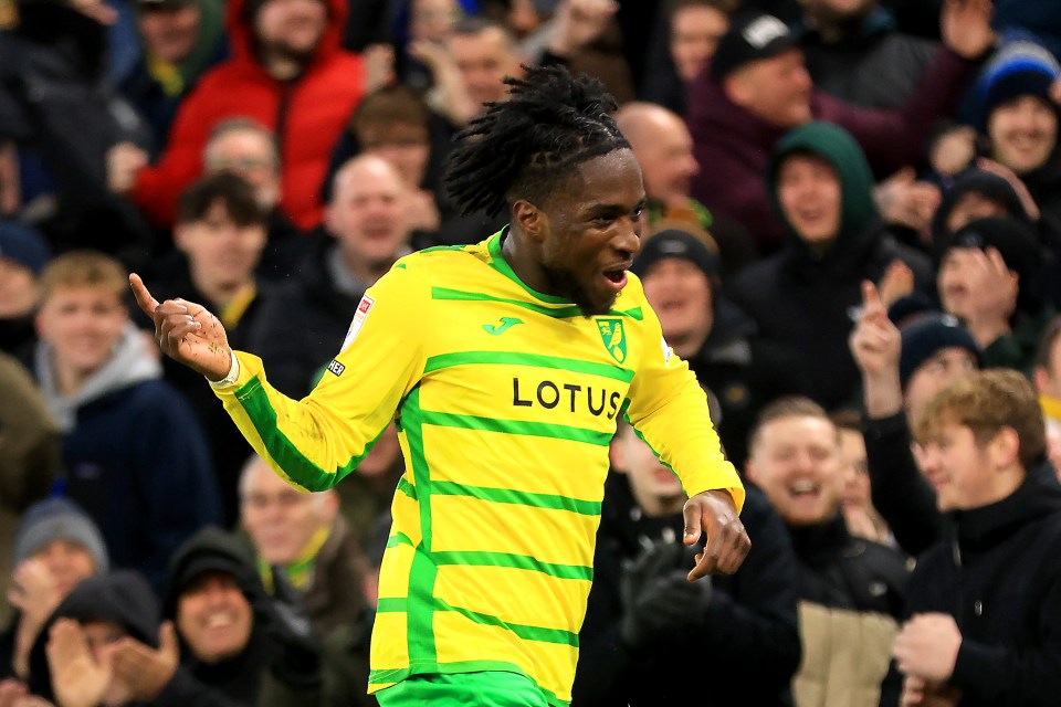 a soccer player wearing a yellow and green jersey with the word lotus on it