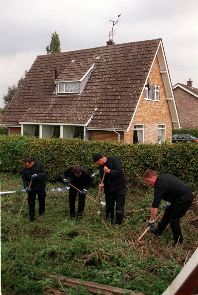 a group of men are working in front of a house