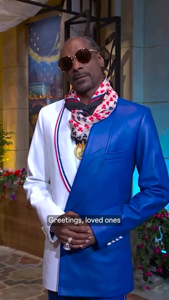 a man wearing a blue and white suit and a scarf says greetings loved ones