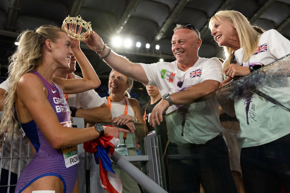 Keely Hodgkinson of Great Britain receives a crown from her father after winning gold in the 800m final.