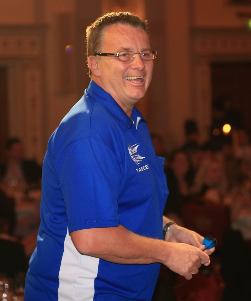 a man wearing a blue shirt with the word table on it