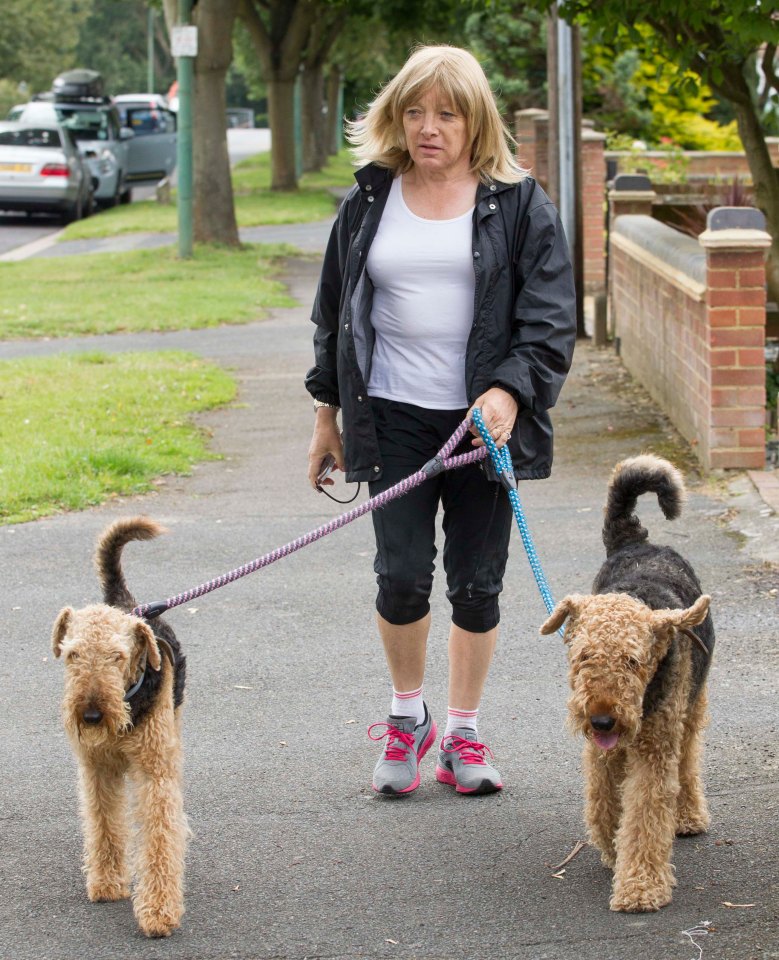 The boxing promoter with her dogs shortly after coming out in 2014