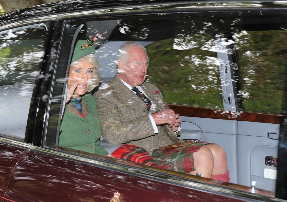 a man in a kilt sits next to a woman in a green jacket