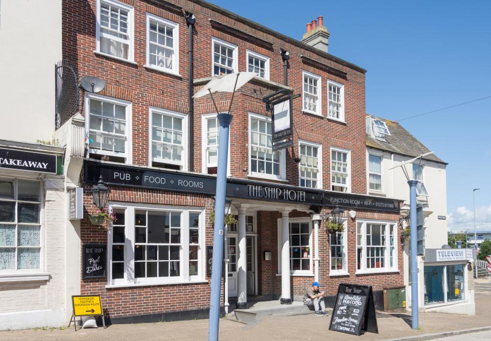 a brick building with a sign that says the ship hotel