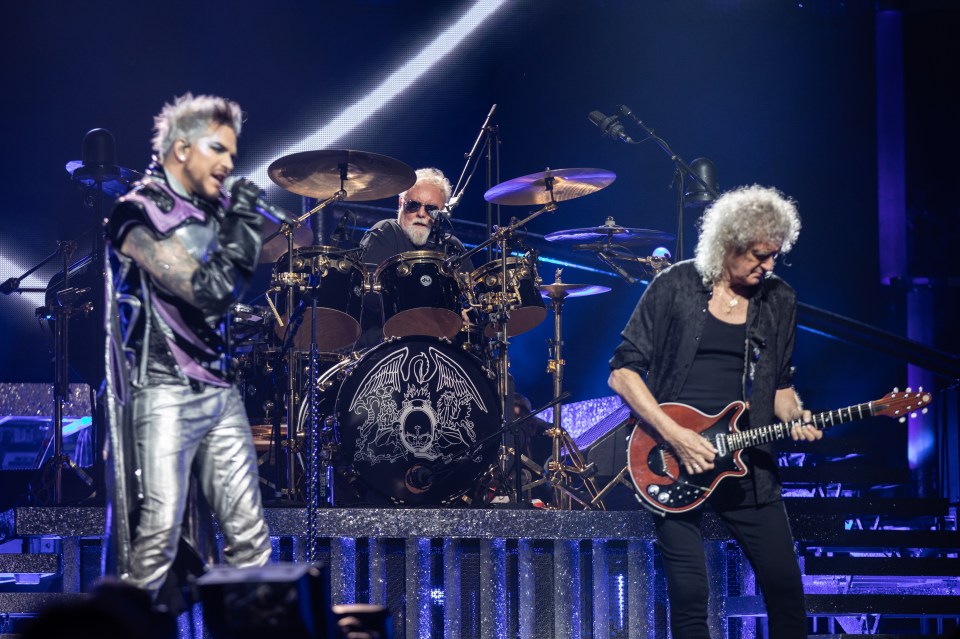 queen 's drummer and guitarist perform on stage