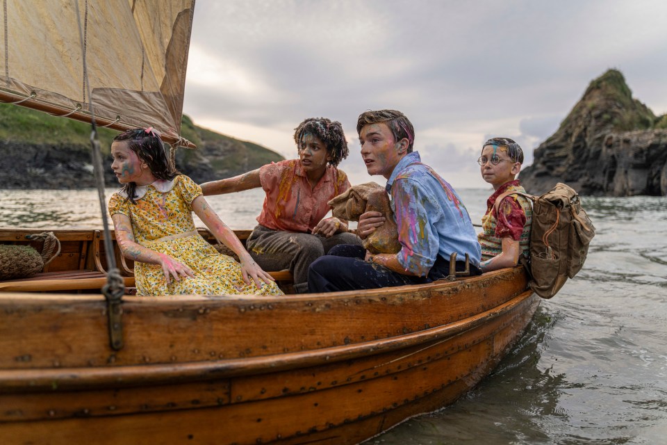 a group of children in a boat with their faces painted