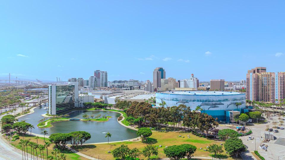 an aerial view of a city with a large building with whales painted on it