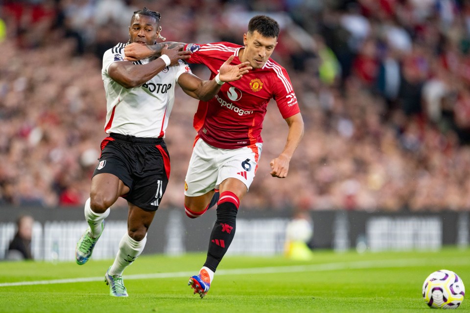 two soccer players on a field with one wearing a red jersey that says ' aotop ' on it