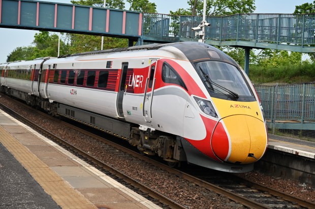 a red and white train with the word lner on the side