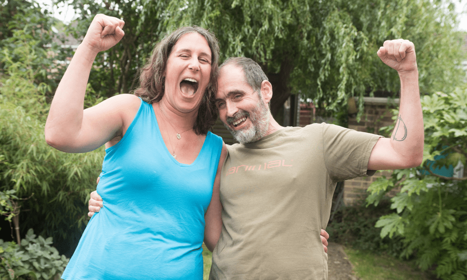 a man and a woman are posing for a picture and the man is wearing a shirt that says animal