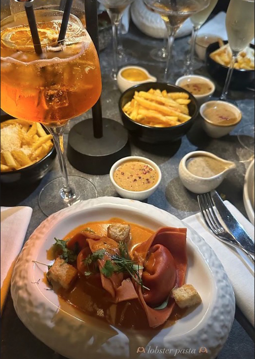 a plate of lobster pasta sits on a table