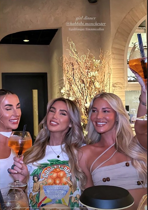 three women are posing for a picture at a girl dinner