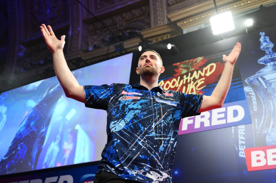 a man in a blue shirt stands in front of a sign that says fred