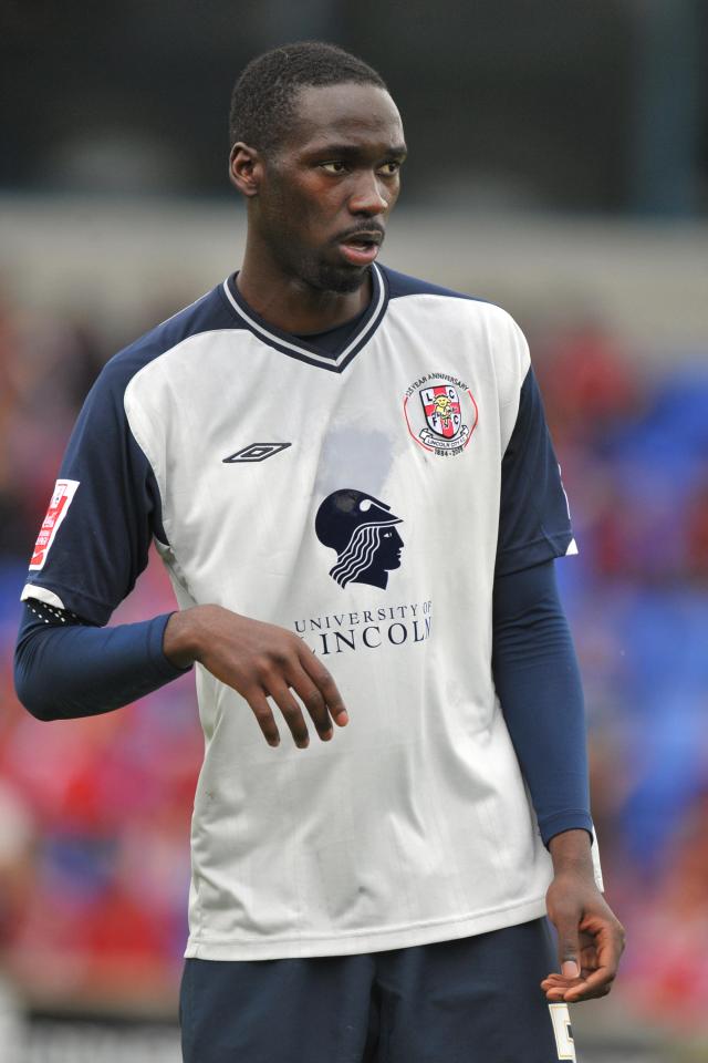 a man wearing a university of incoln jersey