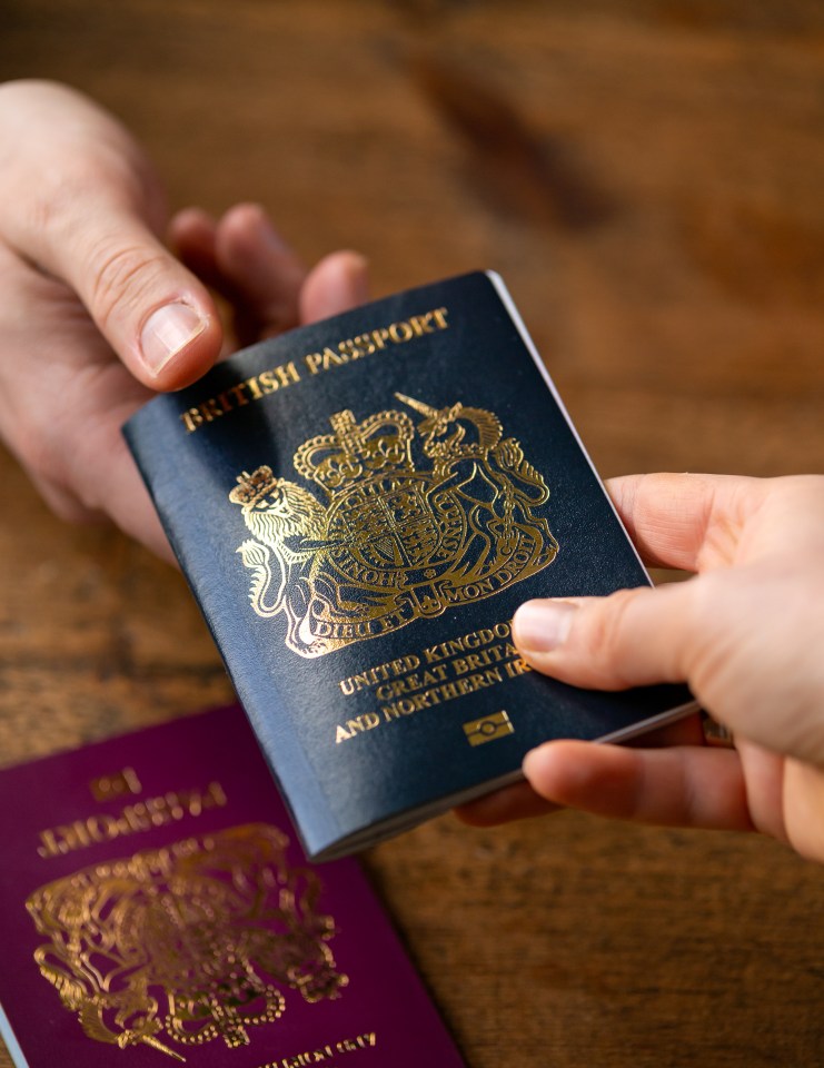 a person handing another person a british passport