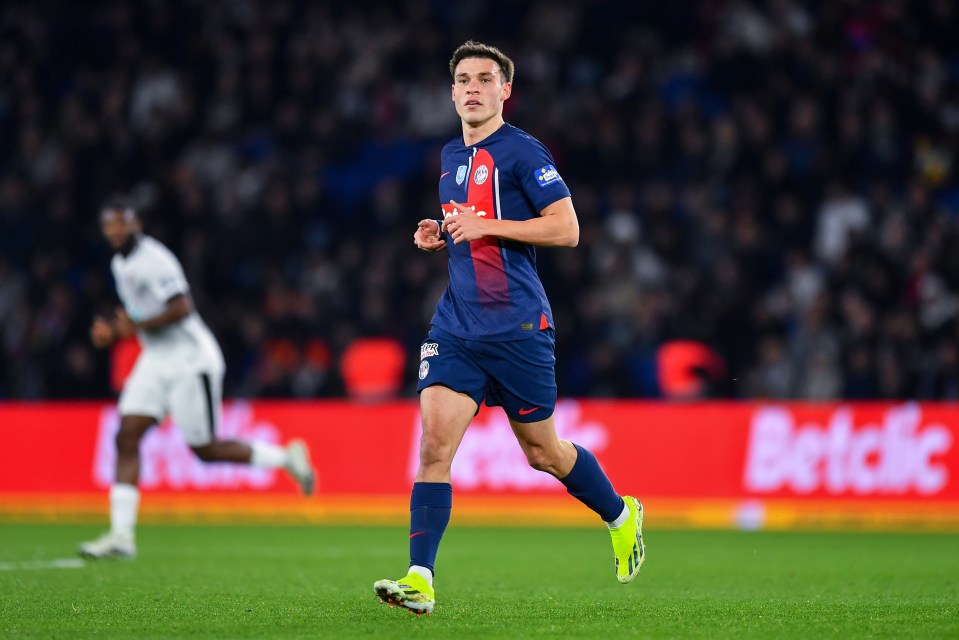 a soccer player running on a field with a betclic ad in the background