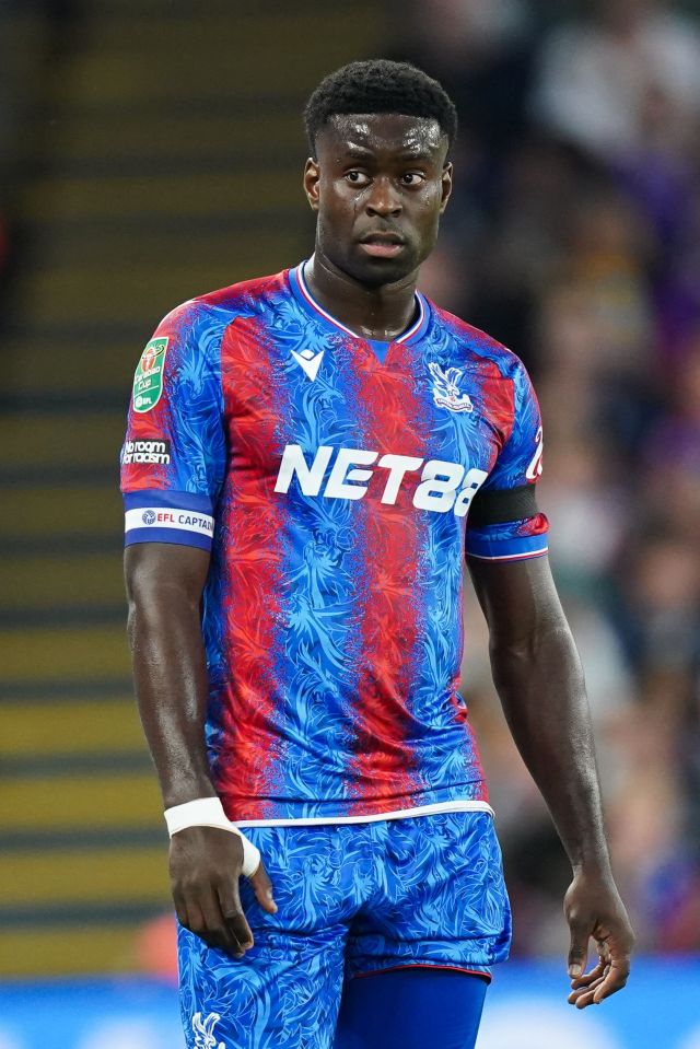 a soccer player wearing a net88 jersey stands on the field