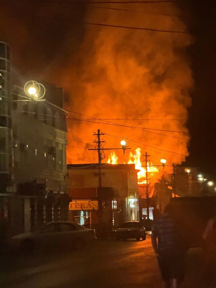 a large fire is coming from a building with a sign that says fenix