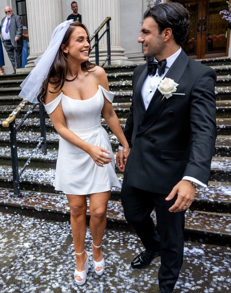 a bride and groom are walking down a set of stairs