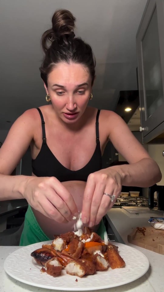 a woman in a black bra is preparing food on a white plate