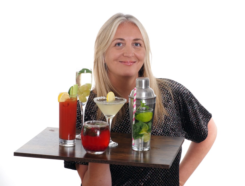 a woman holding a tray of drinks including a martini