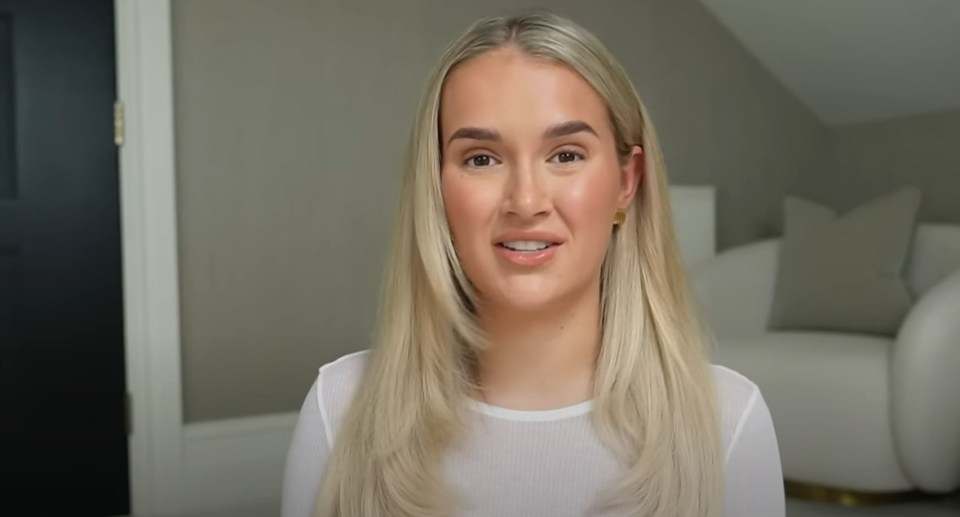 a woman with long blonde hair is wearing a white shirt