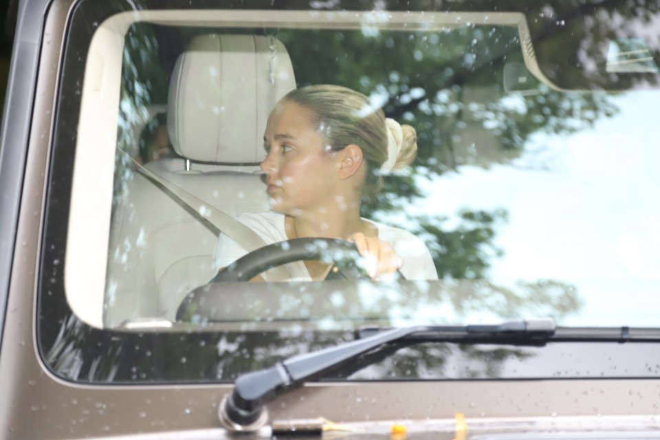 a woman is sitting in the driver 's seat of a car