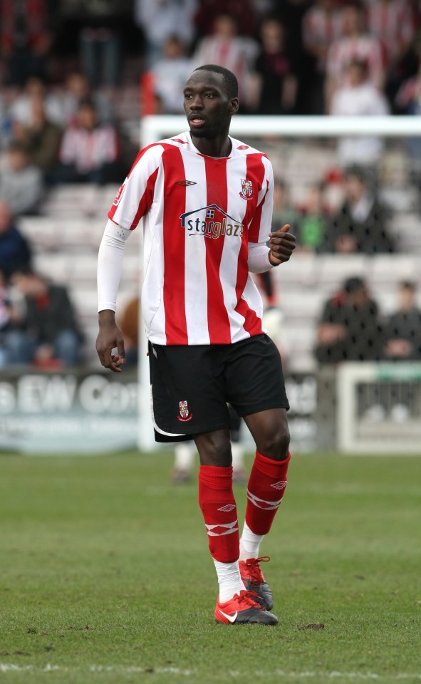 a soccer player wearing a red and white striped shirt that says ' sterling az ' on it