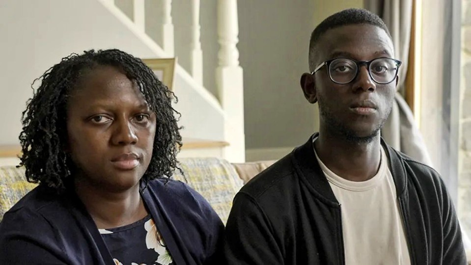 a man and a woman are sitting next to each other on a couch