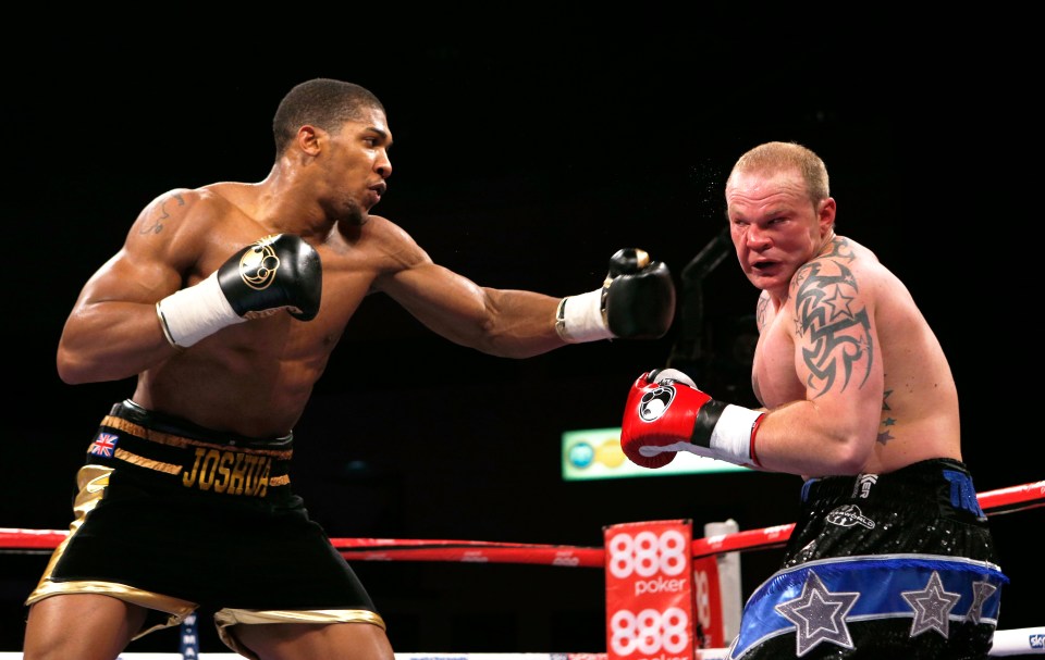 two boxers are fighting in front of a 888 poker sign