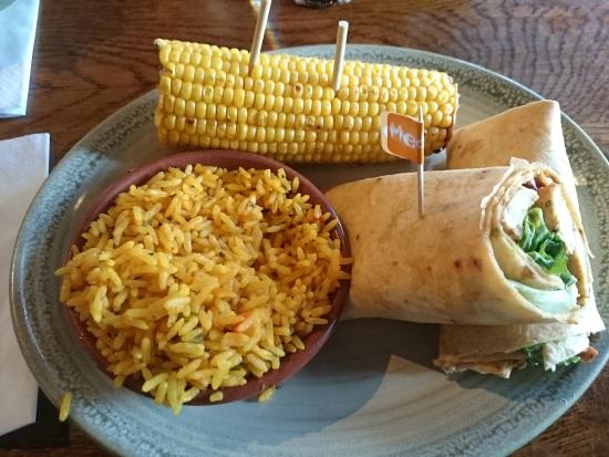 a plate of food with corn on the cob and rice